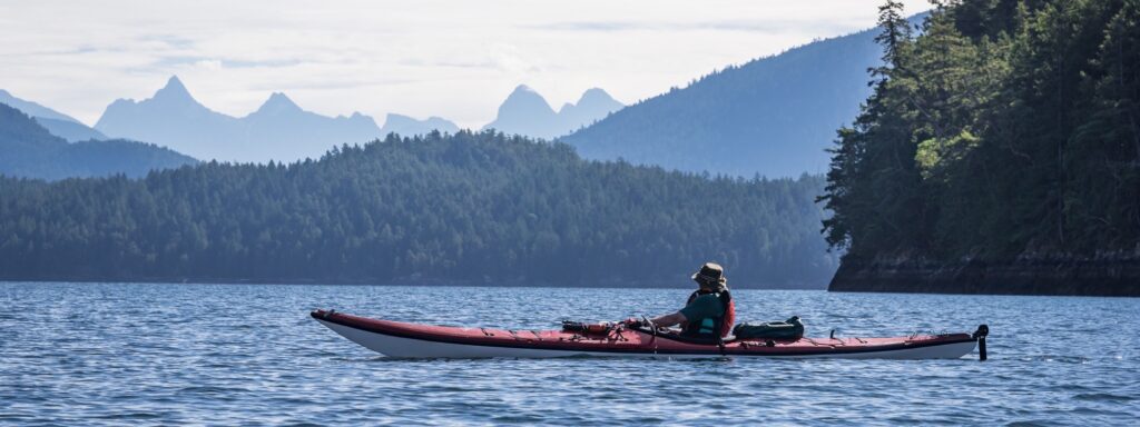 a person in a red kayak on a lake