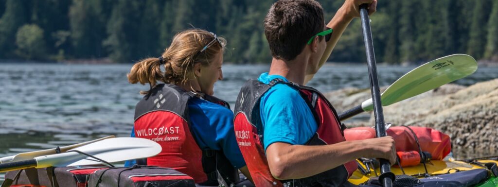 a man and a woman in a kayak on the water