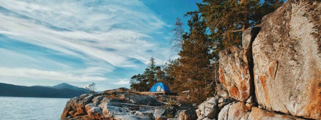 a tent pitched up on the side of a cliff