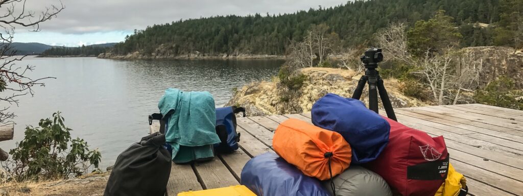 a group of bags sitting on top of a wooden dock
