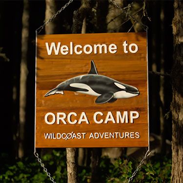 a welcome sign to the orca camp