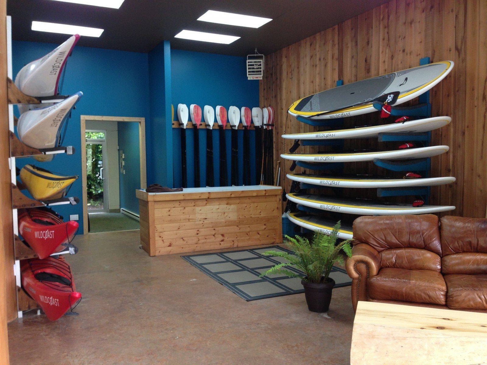 a surfboard rack in a room with leather furniture