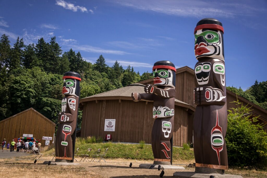 two totemas are standing in front of a building