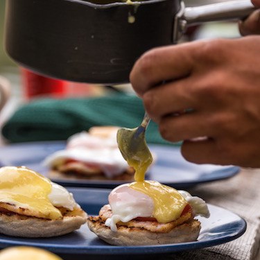 a person is pouring sauce on some food