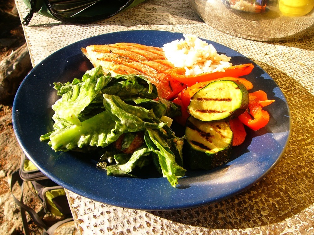 a blue plate topped with vegetables and meat