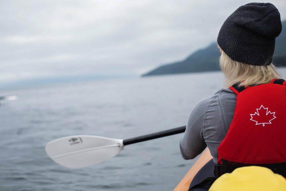 a person in a canoe paddling on the water