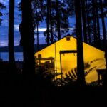 a yellow tent is lit up in the dark