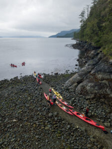 Kakays launching from the beach at Orca Camp to go for the morning paddle