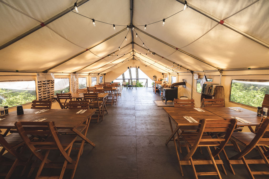 a large tent with tables and chairs inside