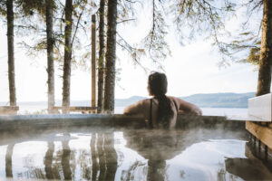 a woman is sitting in a hot tub