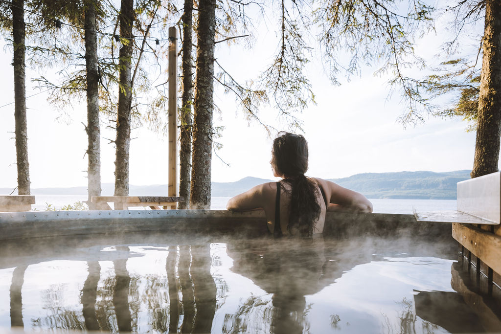 a woman is sitting in a hot tub