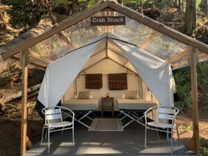 a tent with two chairs and a table under it
