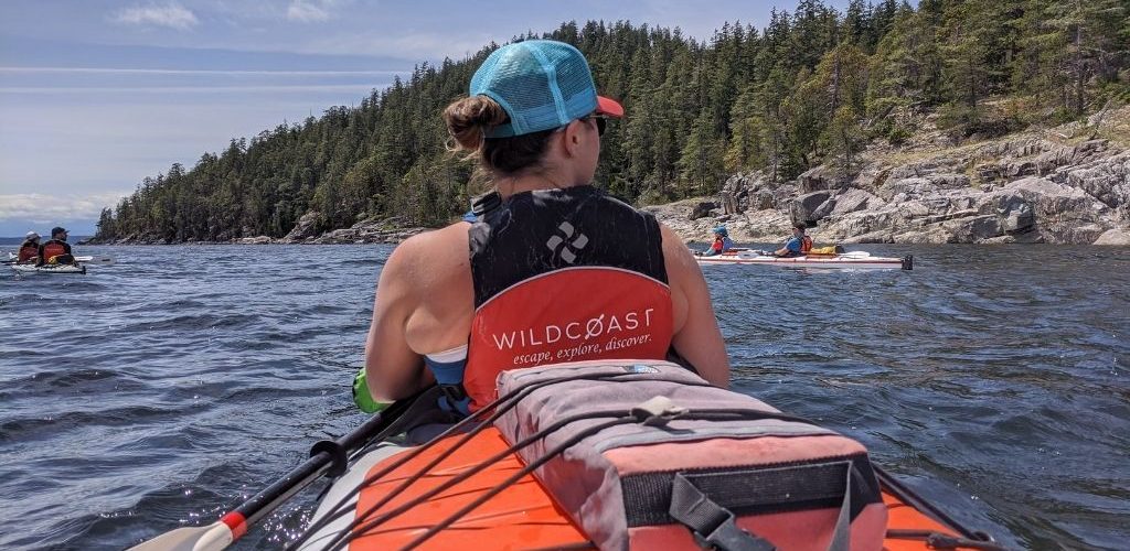 a woman is paddling her kayak in the water