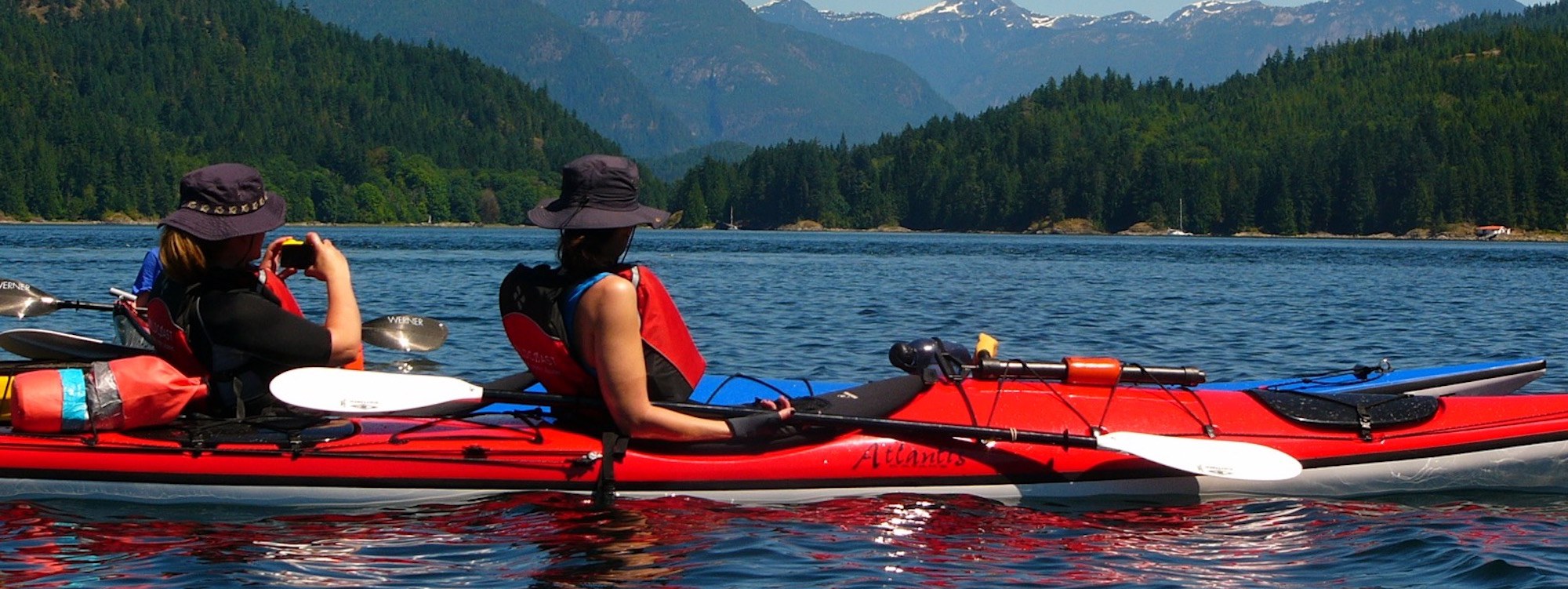 two people sitting on a boat in the water