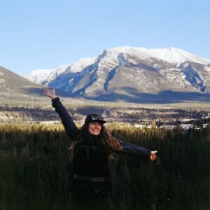 Staff member in front of mountain.